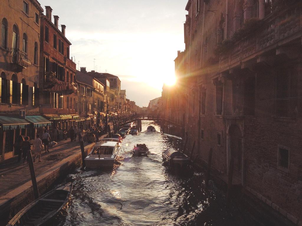 View of Amsterdam canals and historic buildings in golden hour